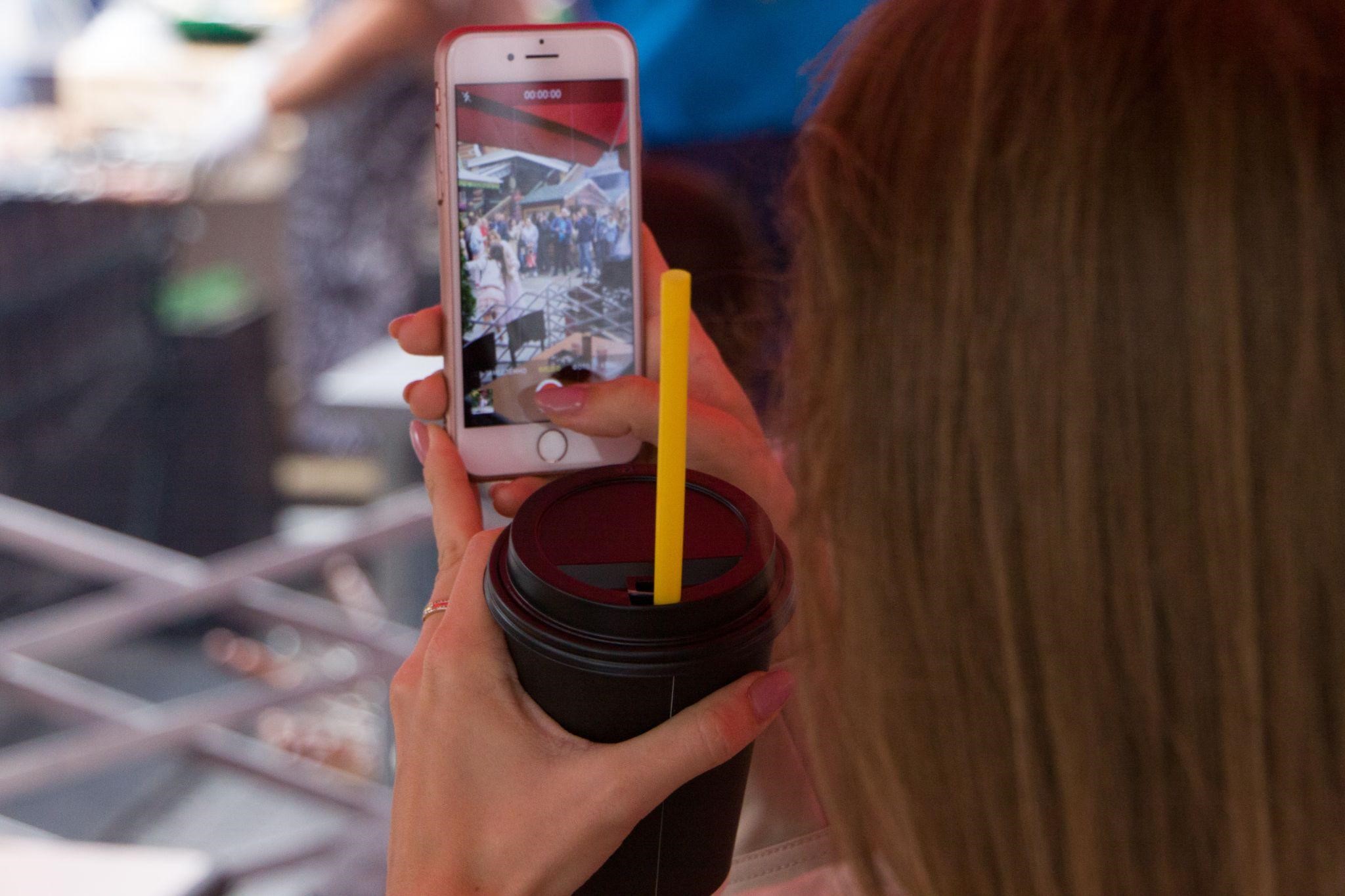 Woman taking a video for Snapchat