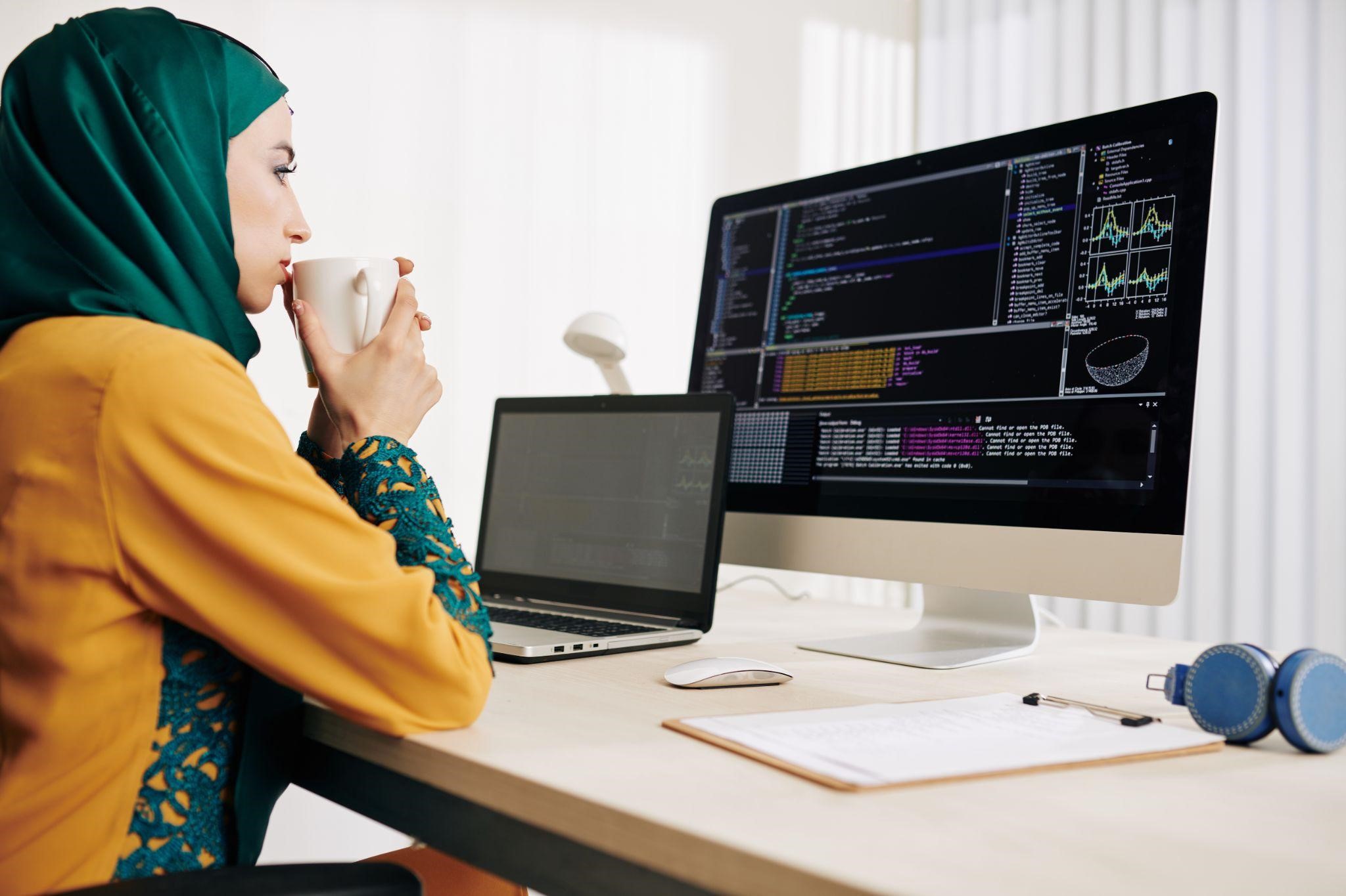 a young female programmer working in Java