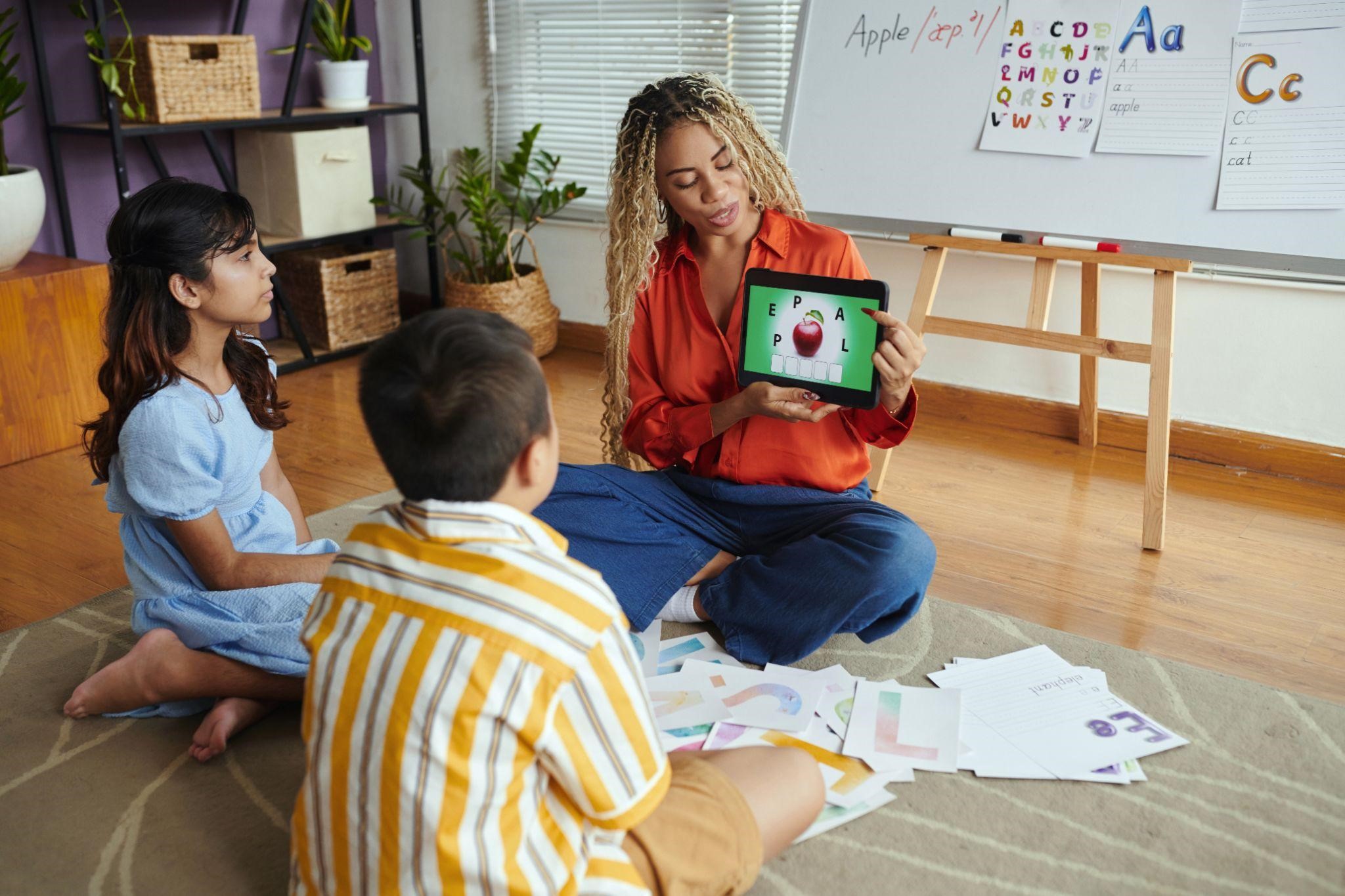 a teacher teaching kids letters using an education app